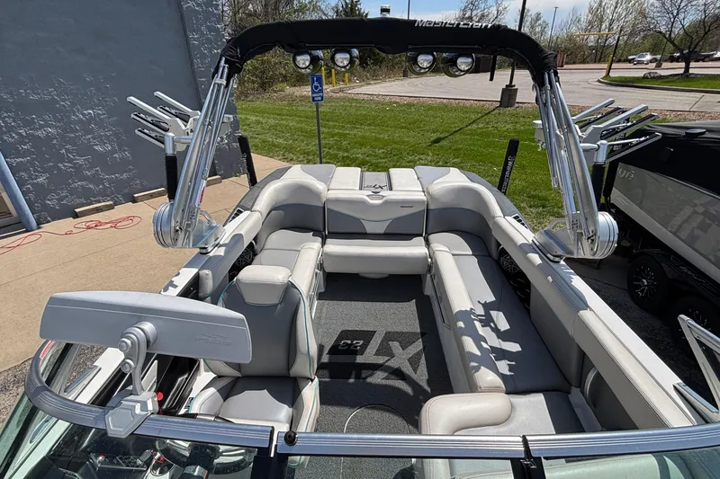 Slide: The Image of 2017 MasterCraft XT23 boat interior with gray seating and wakeboard tower. - 53