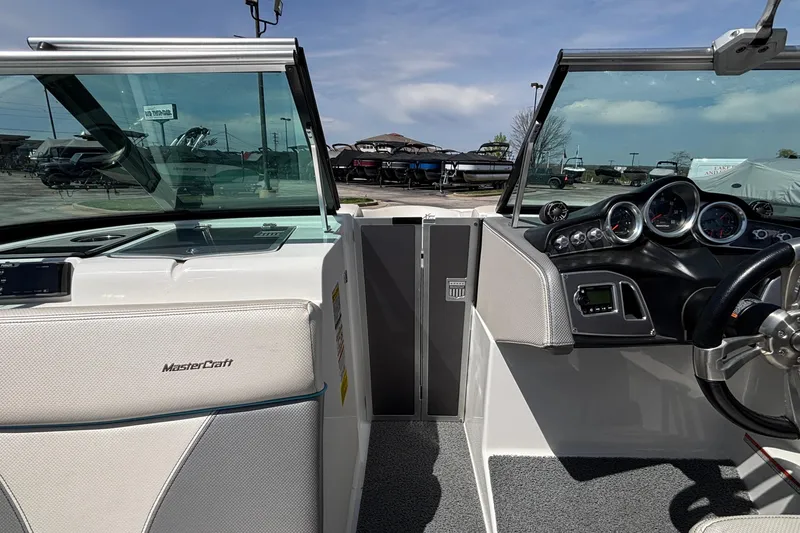 Slide: The Image of 2017 MasterCraft XT23 boat interior with dashboard and steering wheel. - 54