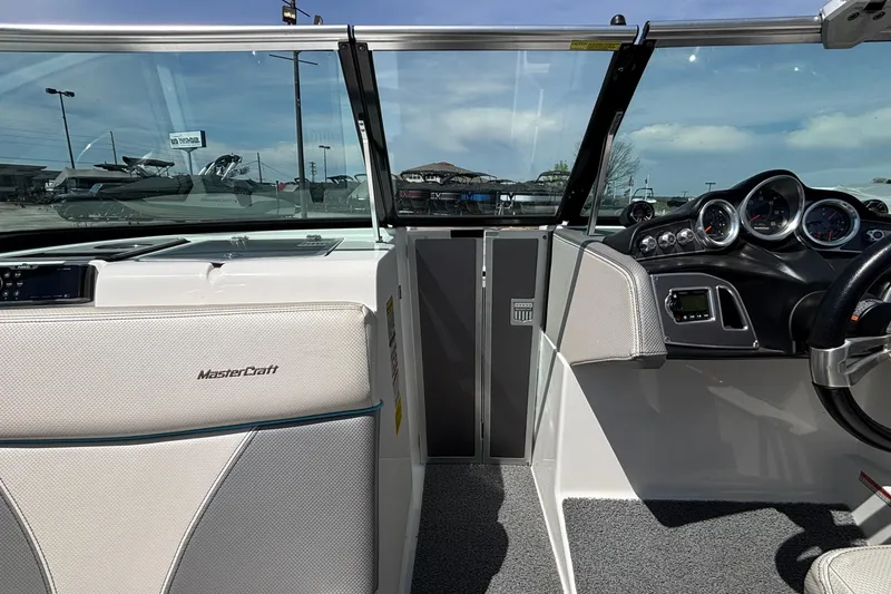 Slide: The Image of 2017 MasterCraft XT23 boat interior with dashboard and steering wheel. - 55