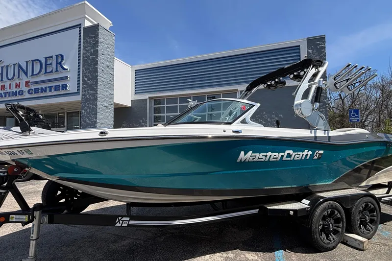 Slide: The Image of 2017 MasterCraft XT23 boat on trailer outside Thunder Marine Center. - 59
