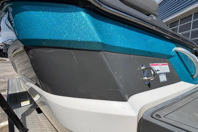 Slide: The Image of 2017 MasterCraft XT23 boat with blue and black exterior detailing. - 64