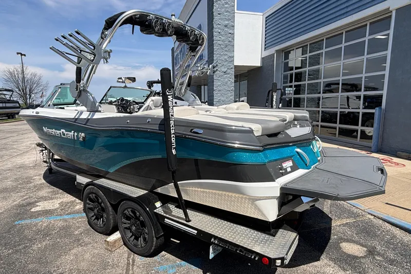 Slide: The Image of 2017 MasterCraft XT23 boat on trailer, parked outside dealership. - 69