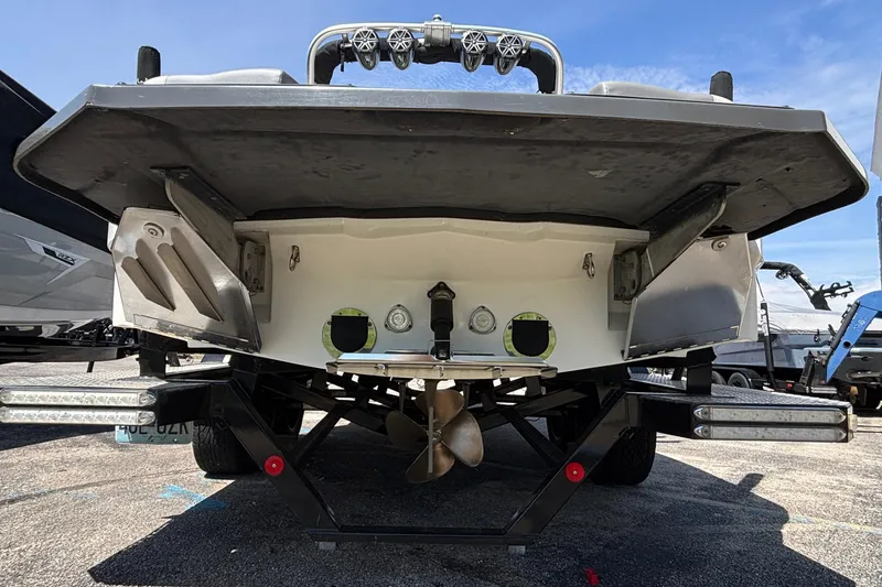Slide: The Image of Rear view of a 2017 MasterCraft XT23 boat on a trailer, showcasing propeller and hull design. - 71