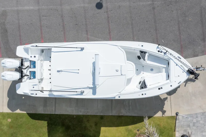Slide: The Image of Aerial view of 2026 Crevalle 33 CSF boat docked, showcasing sleek design and twin engines. - 10