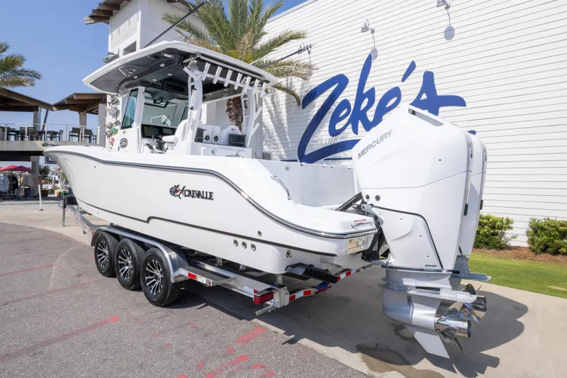 Slide: The Image of 2026 Crevalle 33 CSF boat with dual Mercury engines on a trailer at Zeke's Marina. - 12
