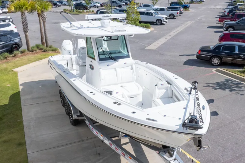 Slide: The Image of 2026 Crevalle 33 CSF boat on trailer in parking lot, surrounded by cars. - 13