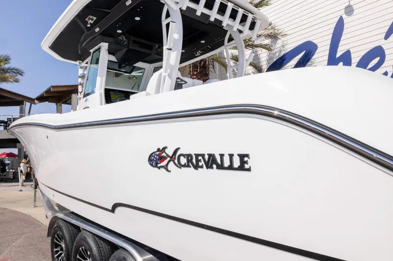 Slide: The Image of 2026 Crevalle 33 CSF boat displayed outdoors, showcasing sleek design and branding. - 19