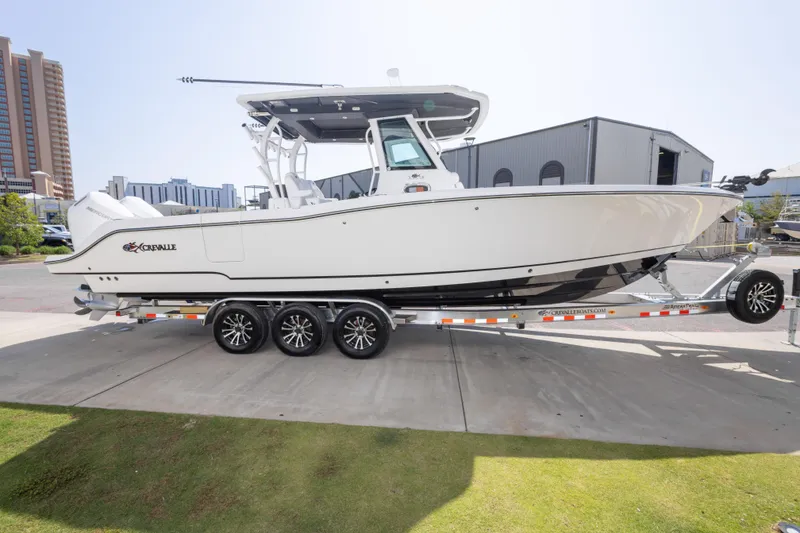 Slide: The Image of 2026 Crevalle 33 CSF boat on trailer, parked outdoors near buildings. - 20