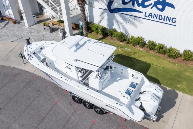 Slide: The Image of 2026 Crevalle 33 CSF boat parked at Lakes Landing, featuring triple Mercury engines. - 22