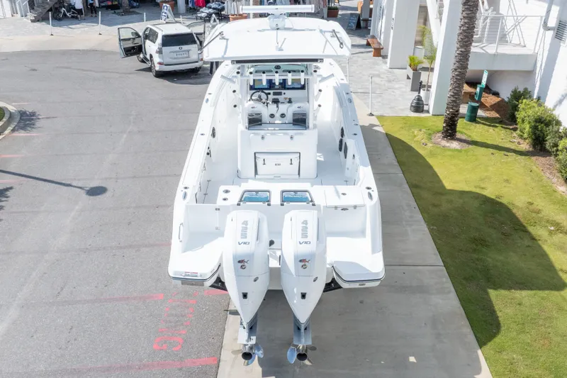 Slide: The Image of 2026 Crevalle 33 CSF boat with twin V10 engines, parked on a concrete surface. - 25