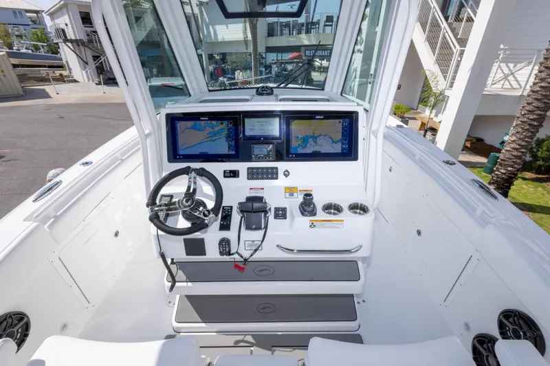 Slide: The Image of 2026 Crevalle 33 CSF boat cockpit with advanced navigation displays and steering wheel. - 28