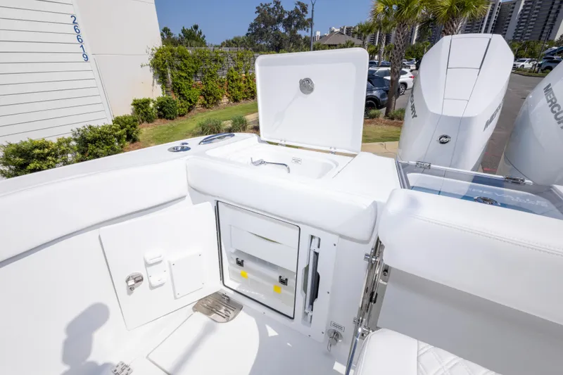Slide: The Image of 2026 Crevalle 33 CSF boat interior with storage compartments and Mercury engines. - 36