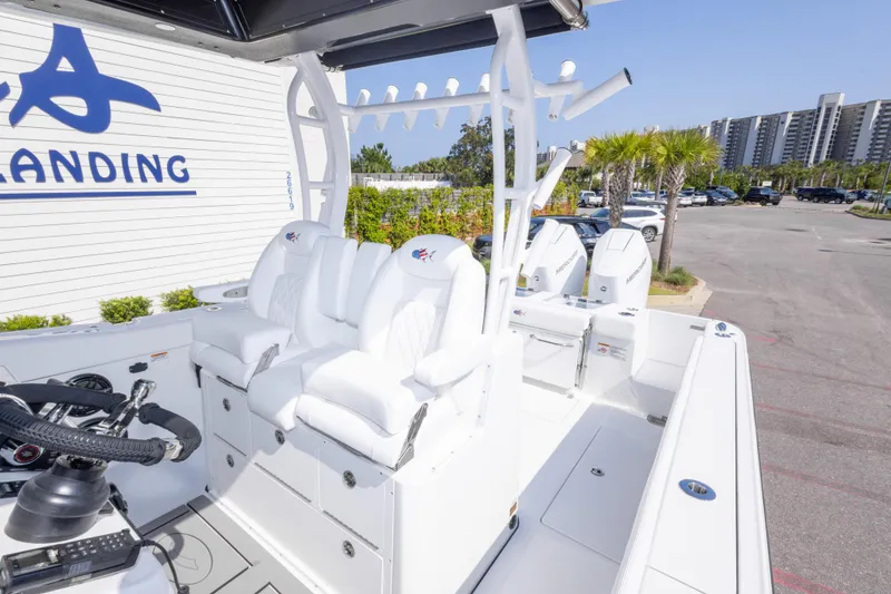 Slide: The Image of 2026 Crevalle 33 CSF boat with white seating and modern controls at a marina. - 45