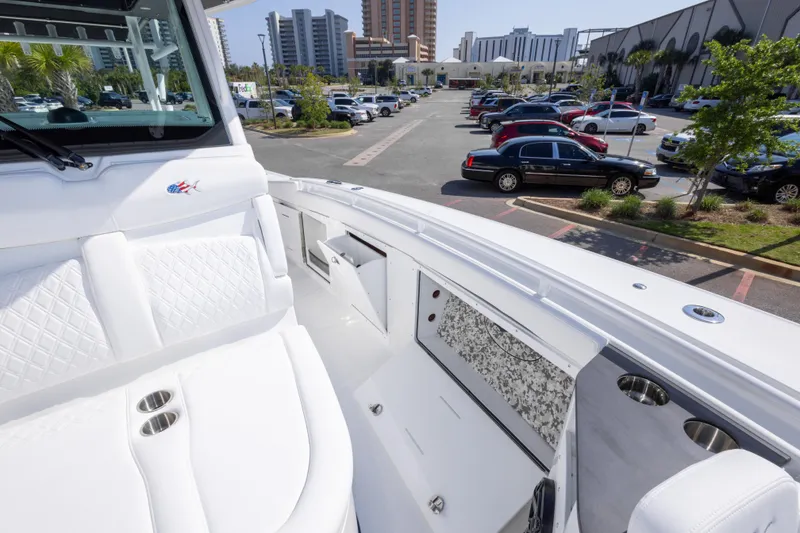 Slide: The Image of 2026 Crevalle 33 CSF boat interior with white seating, parked in urban area. - 52