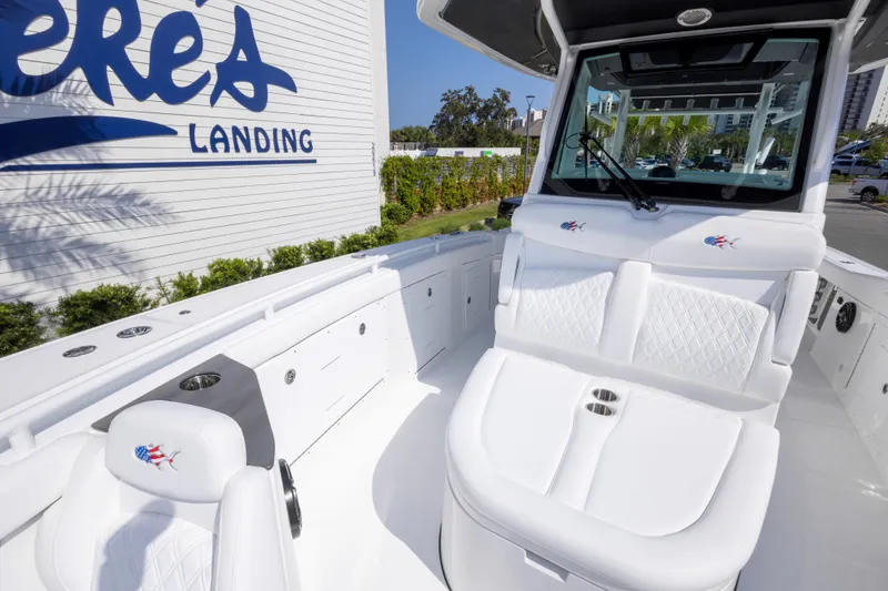 Slide: The Image of 2026 Crevalle 33 CSF boat interior with white seating at a marina. - 53