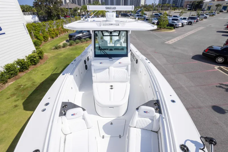 Slide: The Image of 2026 Crevalle 33 CSF boat with spacious deck and seating, parked outdoors. - 55