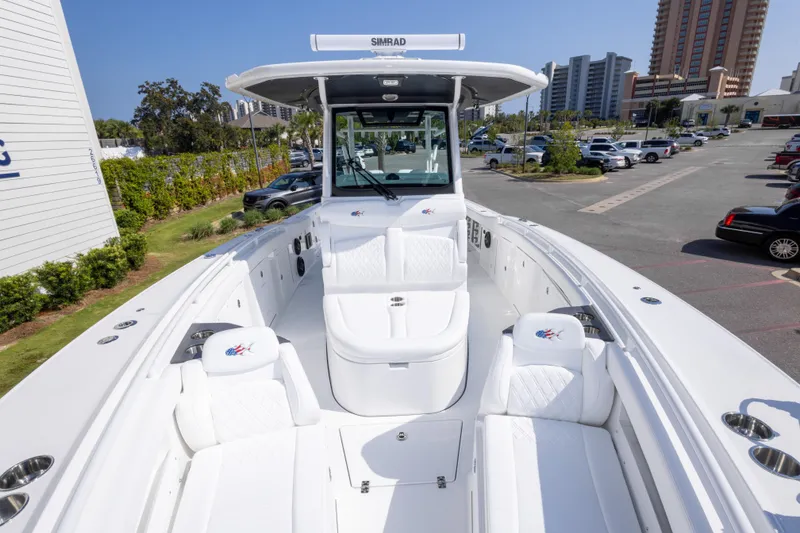 Slide: The Image of 2026 Crevalle 33 CSF boat with white seating, parked in a marina. - 56