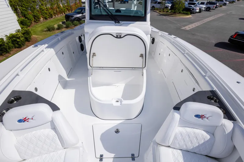 Slide: The Image of 2026 Crevalle 33 CSF boat interior with open storage compartment and cushioned seating. - 57