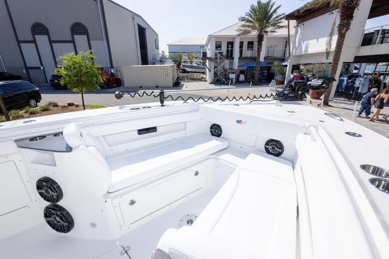 Slide: The Image of 2026 Crevalle 33 CSF boat interior with seating and speakers at a marina. - 59