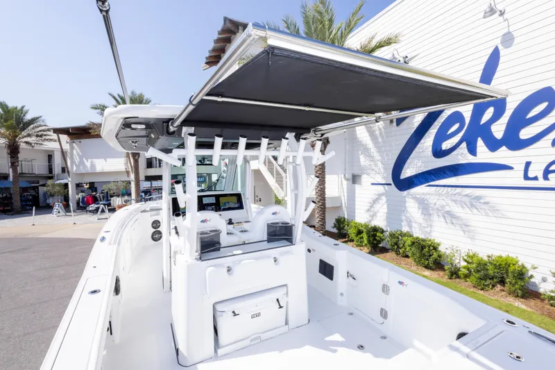 Slide: The Image of 2026 Crevalle 33 CSF boat with T-top, docked near a building. - 63