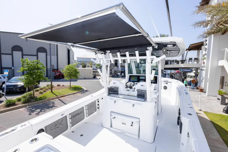 Slide: The Image of 2026 Crevalle 33 CSF boat with modern helm and seating, docked outdoors. - 64