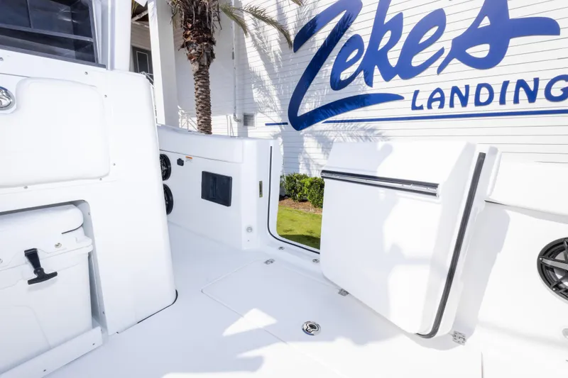 Slide: The Image of 2026 Crevalle 33 CSF boat interior at Zeke's Landing, featuring sleek white design. - 66