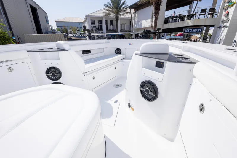 Slide: The Image of 2026 Crevalle 33 CSF boat interior with white seating and built-in speakers. - 69