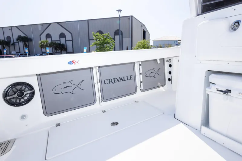 Slide: The Image of 2026 Crevalle 33 CSF boat interior with storage compartments and speaker. - 73