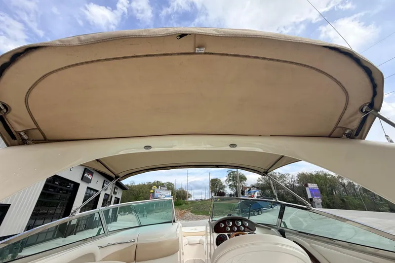 Slide: The Image of 2002 Sea Ray 290 Bowrider boat interior with canopy and dashboard view. - 10