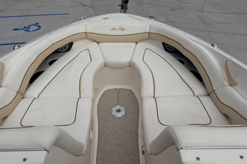 Slide: The Image of 2002 Sea Ray 290 Bowrider boat with spacious white seating area. - 11