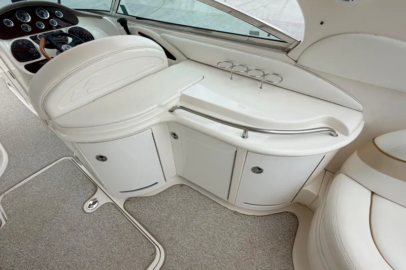 Slide: The Image of Interior of 2002 Sea Ray 290 Bowrider boat, featuring helm and seating area. - 17