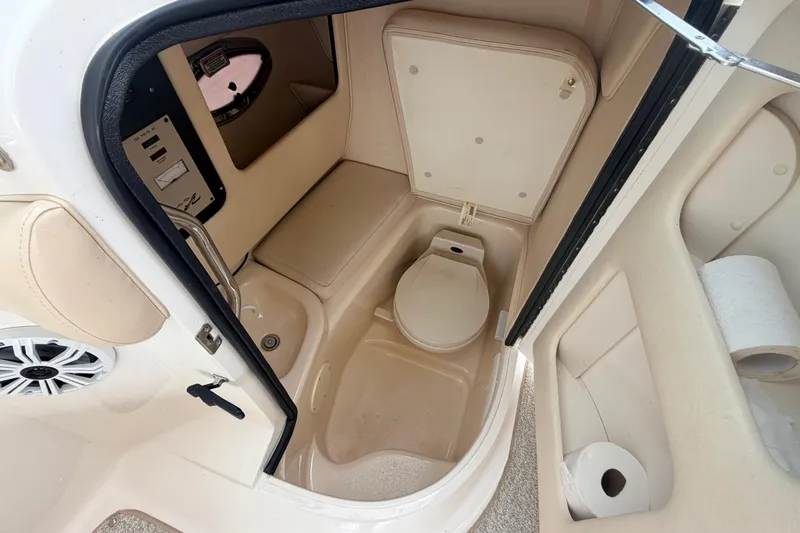 Slide: The Image of 2002 Sea Ray 290 Bowrider boat bathroom interior with toilet and storage compartments. - 22
