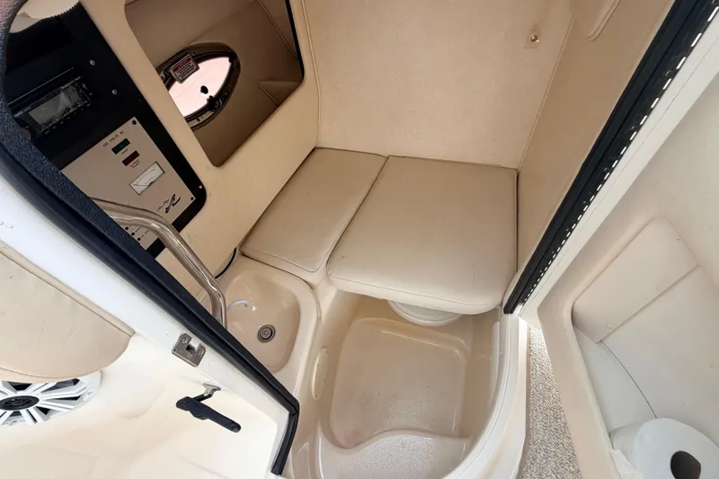 Slide: The Image of Interior cabin of 2002 Sea Ray 290 Bowrider boat with seating and control panel. - 23