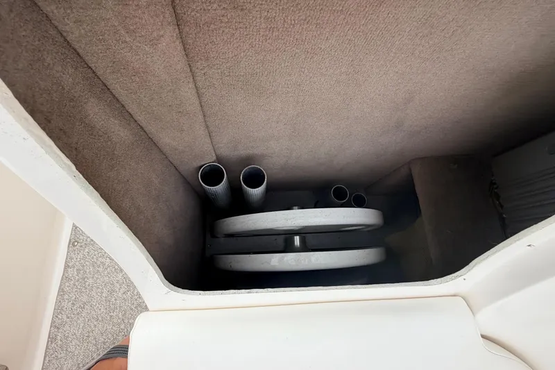 Slide: The Image of Storage compartment in a 2002 Sea Ray 290 Bowrider boat, featuring pipes and equipment. - 28