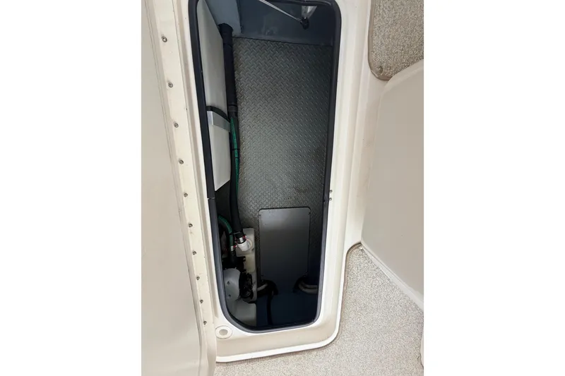 Slide: The Image of Storage compartment of a 2002 Sea Ray 290 Bowrider boat, featuring interior details. - 29
