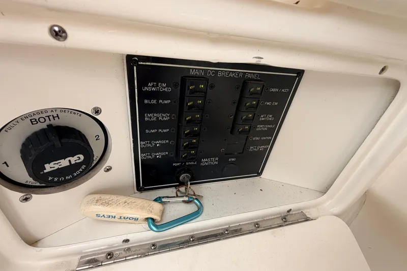 Slide: The Image of 2002 Sea Ray 290 Bowrider main DC breaker panel with boat keys. - 30