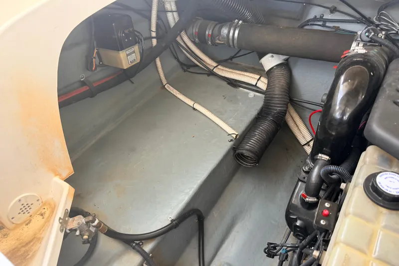 Slide: The Image of Engine compartment of a 2002 Sea Ray 290 Bowrider, showing hoses and components. - 33