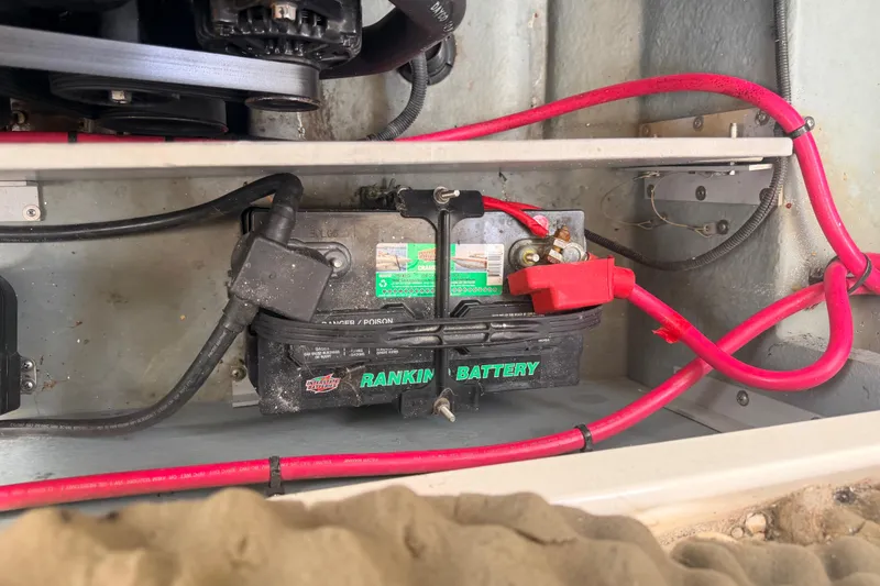 Slide: The Image of Battery compartment of a 2002 Sea Ray 290 Bowrider boat with red cables. - 35