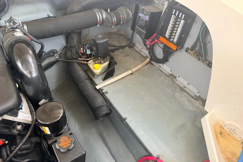 Slide: The Image of Engine compartment of a 2002 Sea Ray 290 Bowrider, showing mechanical components and wiring. - 36