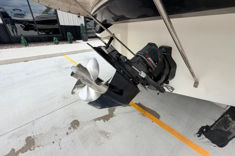 Slide: The Image of 2002 Sea Ray 290 Bowrider boat propeller and outdrive on concrete surface. - 38