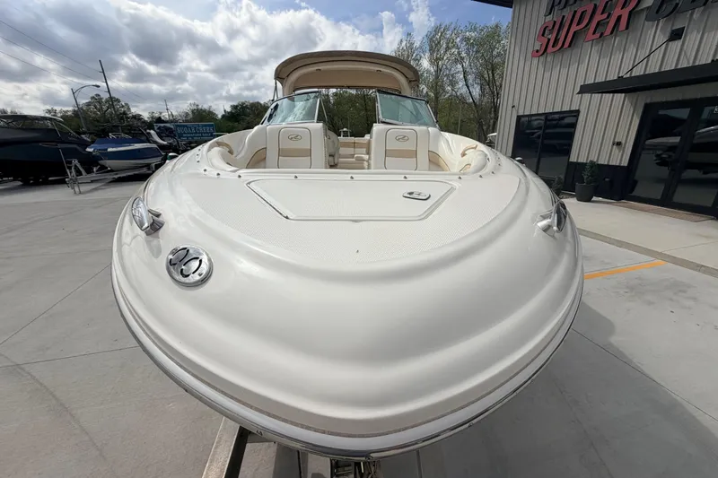 Slide: The Image of 2002 Sea Ray 290 Bowrider boat displayed outdoors at a dealership. - 6