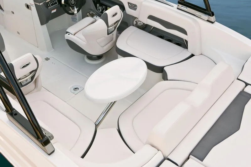 Slide: The Image of Manufacturer Provided Image: 2016 Chaparral 246 SSi boat interior with white seating and round table. - 13