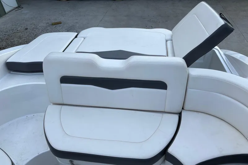 Slide: The Image of 2016 Chaparral 246 SSi boat interior with white and gray seating arrangement. - 3