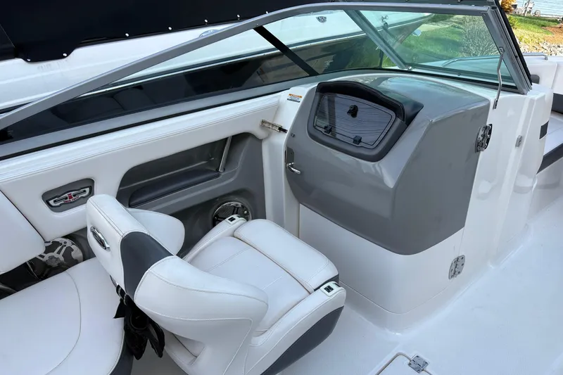 Slide: The Image of Interior of a 2016 Chaparral 246 SSi boat with white seating and dashboard. - 4