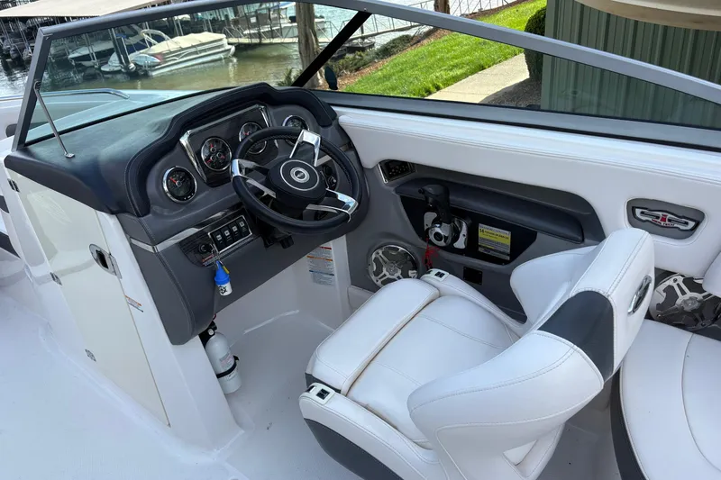 Slide: The Image of Interior view of 2016 Chaparral 246 SSi boat cockpit with steering wheel and controls. - 5