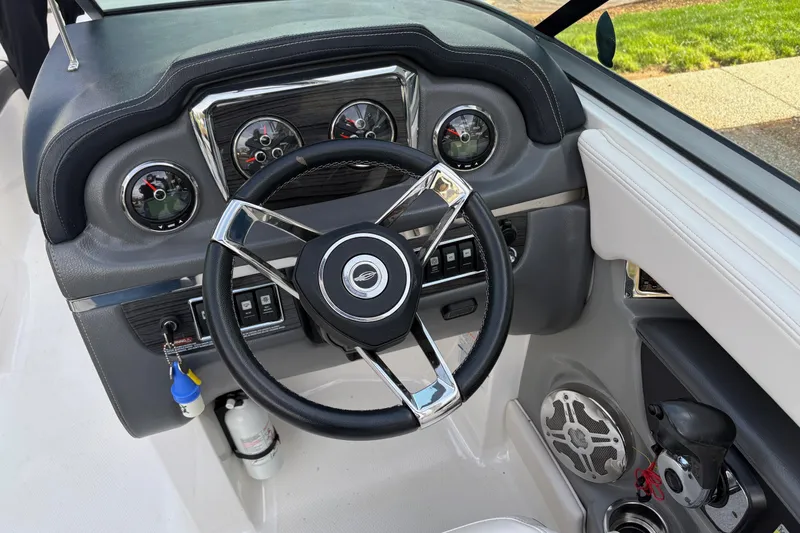 Slide: The Image of 2016 Chaparral 246 SSi boat dashboard with steering wheel and gauges. - 7
