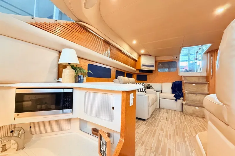 Slide: The Image of Luxurious interior of a 1997 Sea Ray 420 Aft Cabin yacht with modern amenities. - 10
