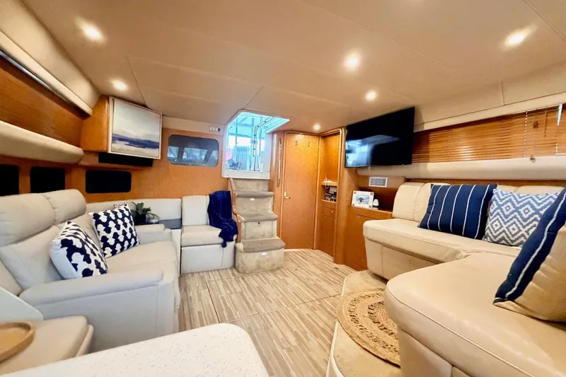 Slide: The Image of Luxurious interior of 1997 Sea Ray 420 Aft Cabin yacht with elegant seating and decor. - 12