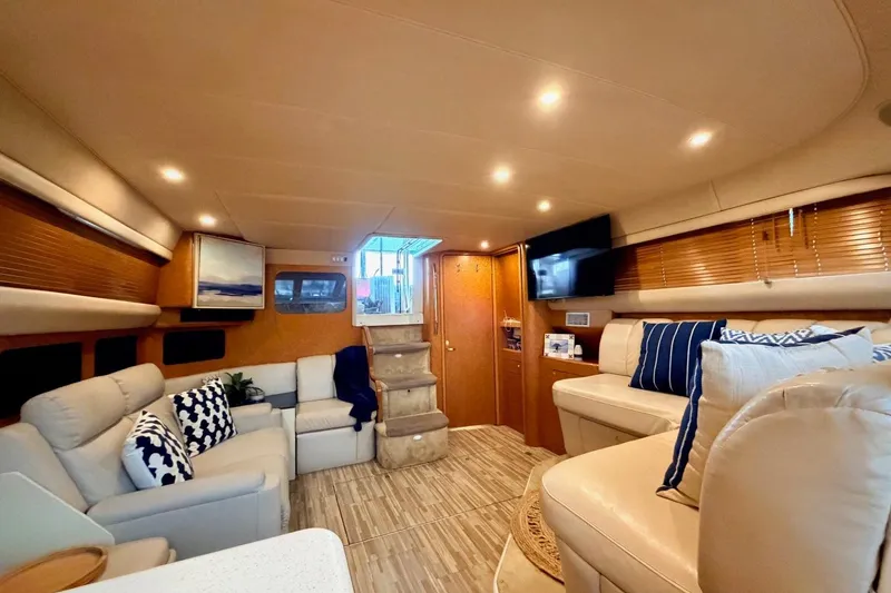 Slide: The Image of Luxurious interior of 1997 Sea Ray 420 Aft Cabin yacht with elegant seating and decor. - 13