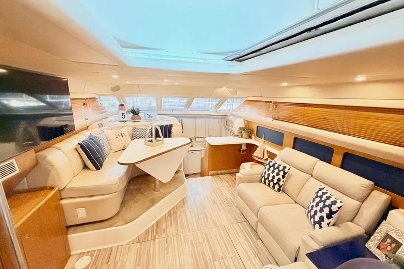 Slide: The Image of Luxurious interior of 1997 Sea Ray 420 Aft Cabin yacht with plush seating and modern decor. - 14